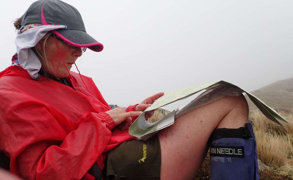 PA110814+Lynette+checks+the+map+on+the+saddle+between+Mt+Gibbs+and+Xenicus+Peak+.JPG